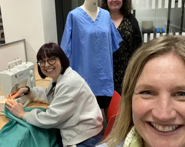 Volunteers in the NHS scrubs hub set up on campus