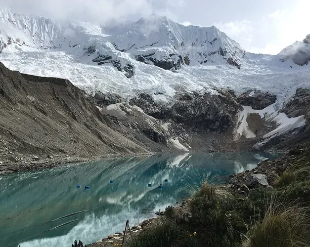 Snow capped mountains around a frozen lake