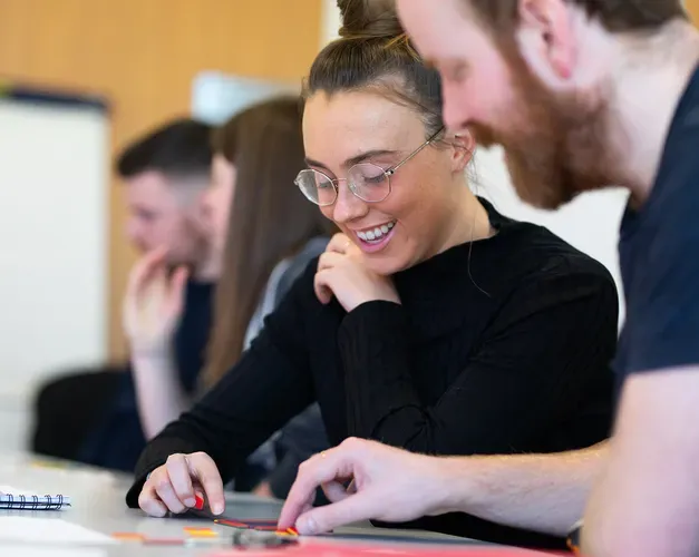 students sitting at a table working