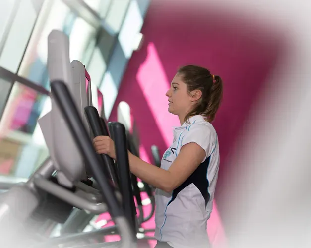 Girl using cross trainer at ISE