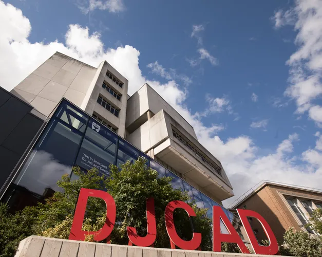 DJCAD building with red letters DJCAD in front of it