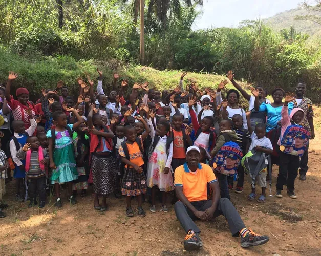 student Jonas Nguh in large group