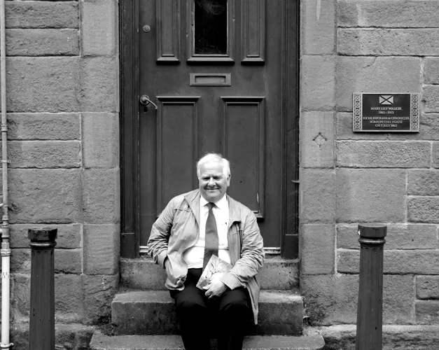 Eddie Small sat on the steps of Mary Lily Walker's house