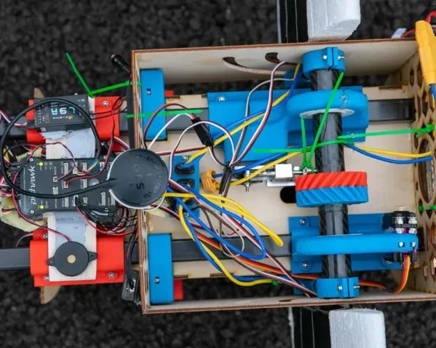 a look inside the machine with various wires and motors