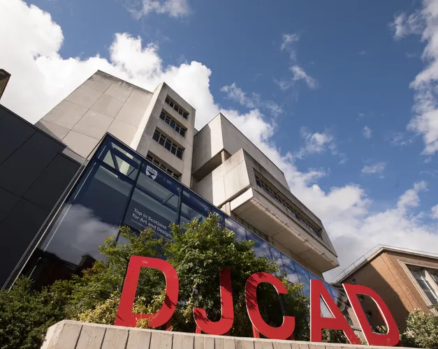 exterior of building with large red letters DJCAD