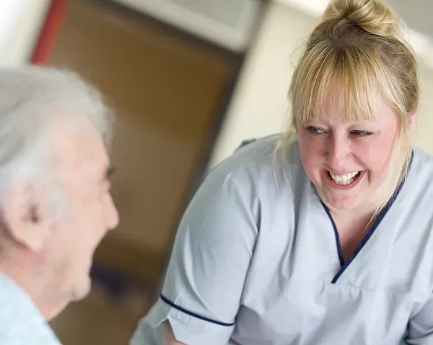 a nurse attending to an old man