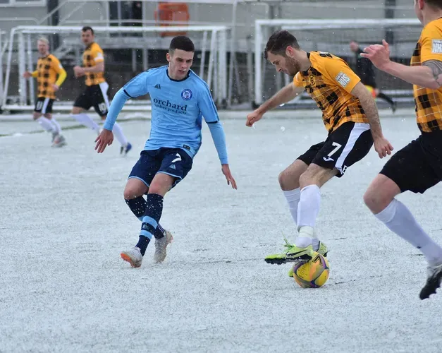 5 men playing football
