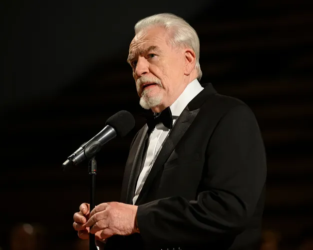 Brian Cox standing in front of a microphone