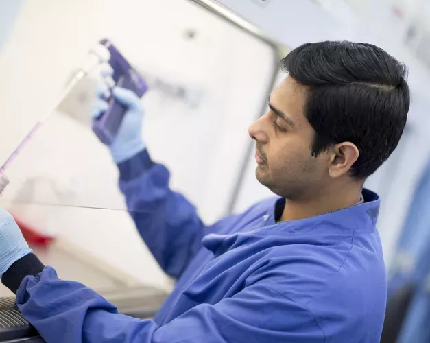scientist filling up tube in lab