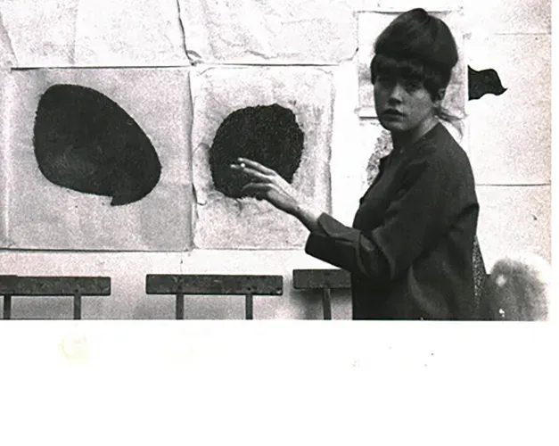 Rita Donagh in front of a large collage work