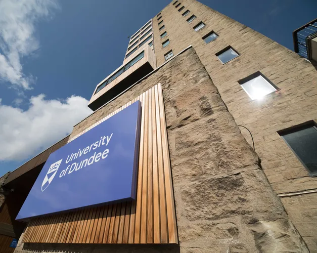 Tower Building with the University of Dundee logo and blue skies above