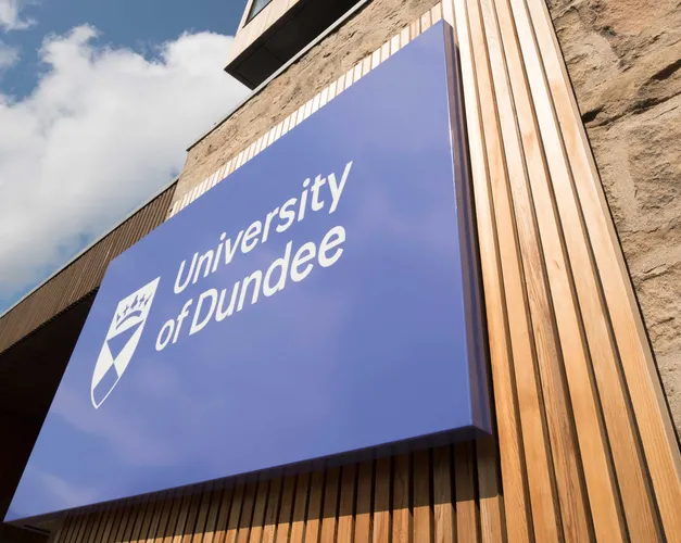 Tower Building with University of Dundee logo and blue skies above