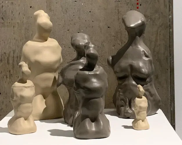 miniature sculptures of a naked woman's body in a mix of light and dark colours