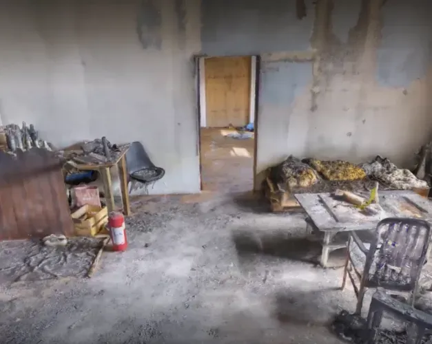 A still image from the digital virtual reality scene showing a burned room