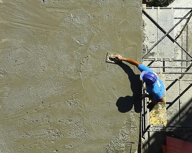 Man laying concrete rotated