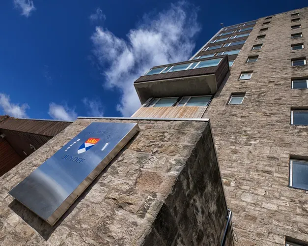 Tower building, looking up at the windows from the outside on sunny day. 