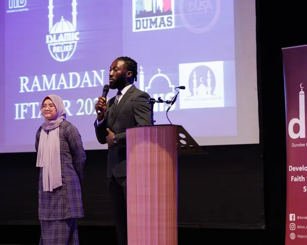 Image of speakers on stage at the iftar event