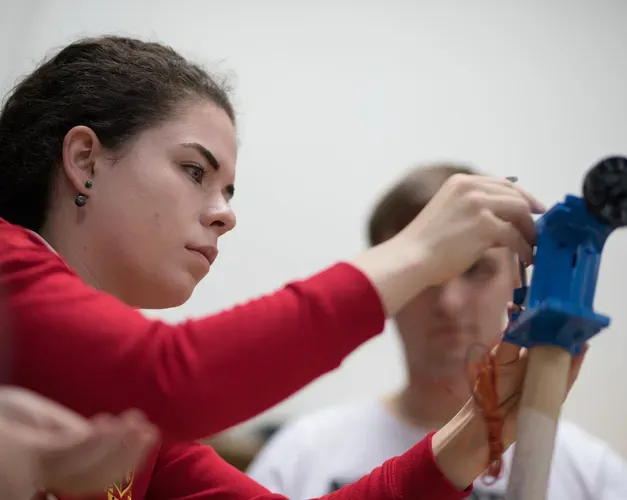 student working on a mechanical device
