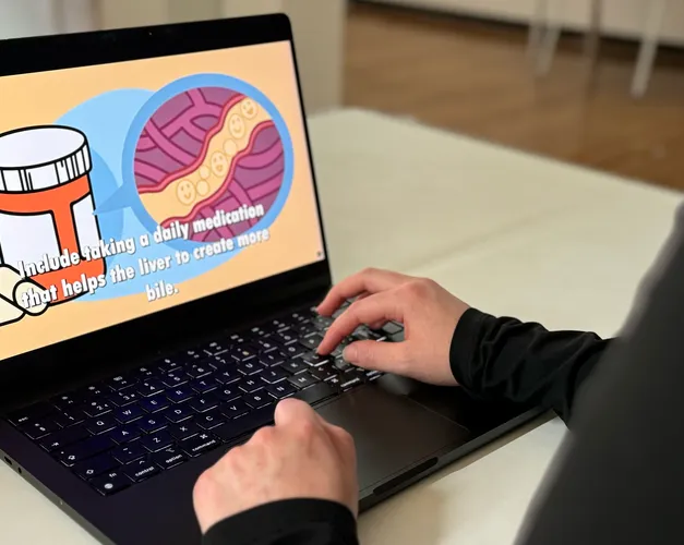 Leah works on a laptop