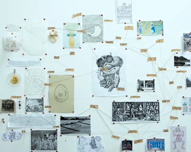 Selection of artwork and images on a wall