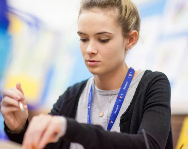 woman working as a teacher holding a pen in hand