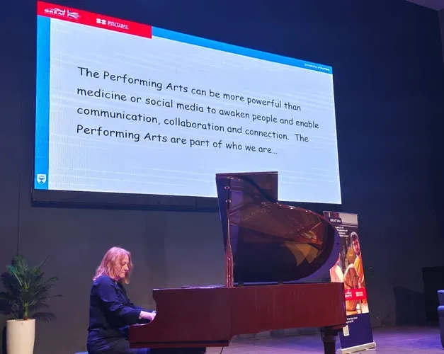 Woman playing piano on stage