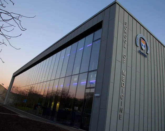 The exterior of the School of Medicine library at sunset