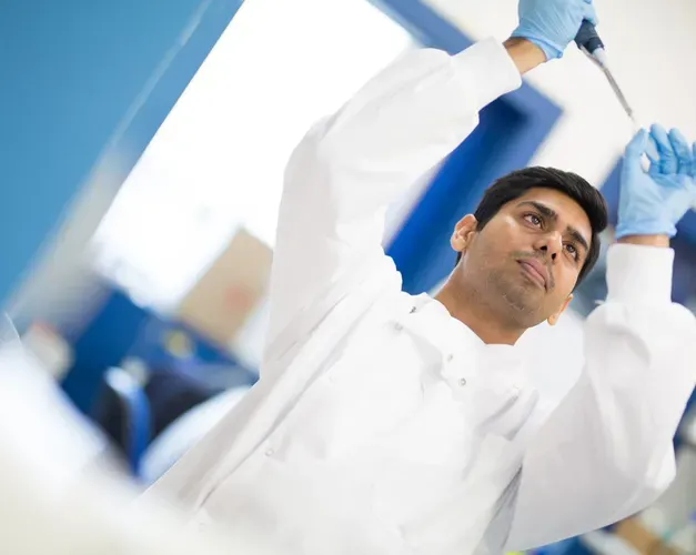Researcher looking at a test tube