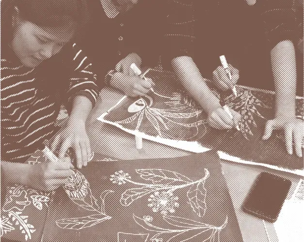 workshop participants designing on a table