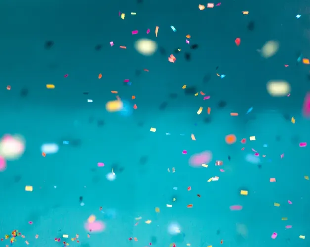 confetti in various colours against a light blue background