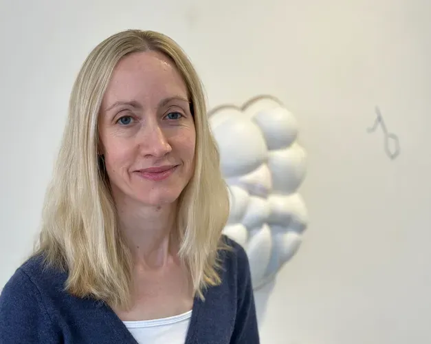 Head and shoulders photo of a woman smiling