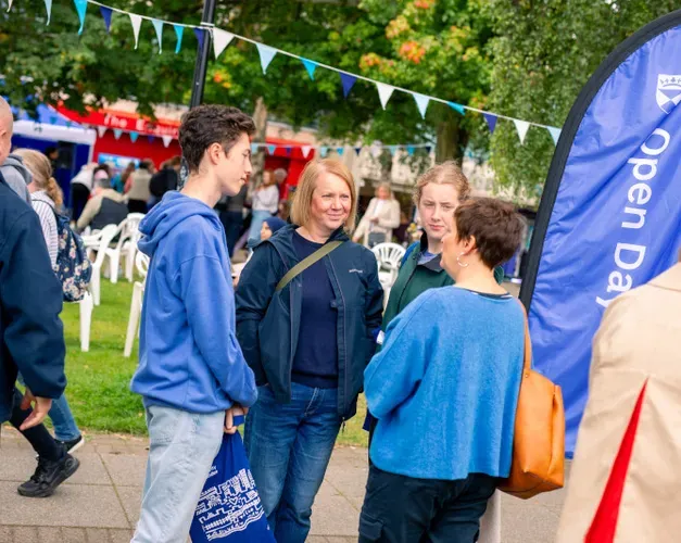 Open day event with groups of families on the campus green