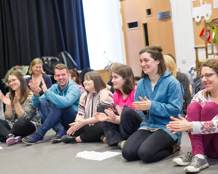 A group of people sitting on the floor