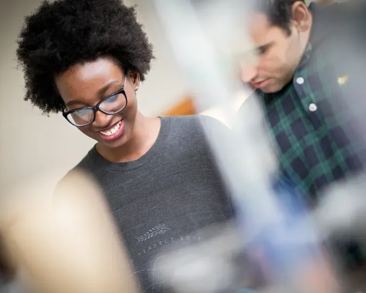 Students smiling in a workshop