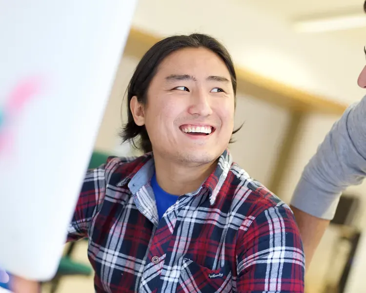 Man smiling at computer