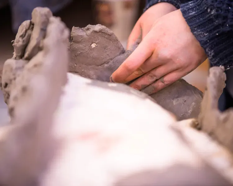 Pair of hands working with clay