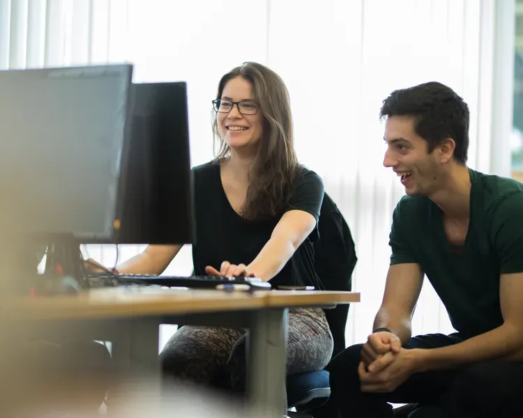 two students working on a computer