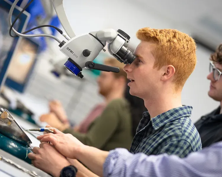 Student looking into a microscope