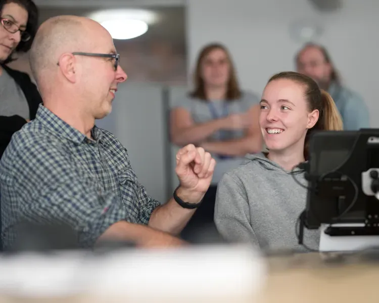 two people laughing and working