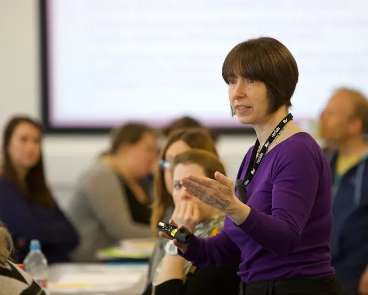 A teacher with a class of older students