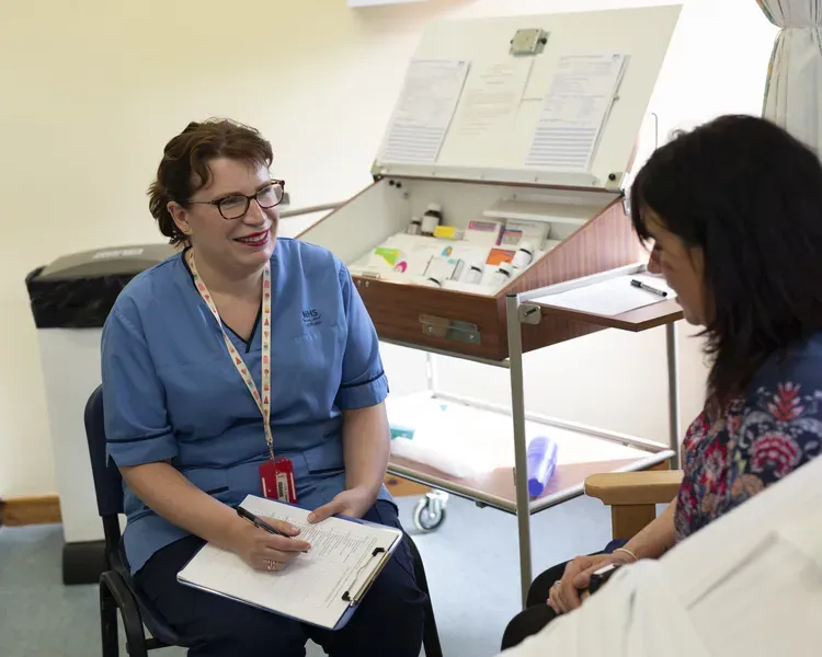 Nursing student in classroom with "patient"