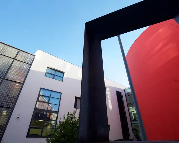 Shot from the ground of the red exterior wall of Dalhousie lecture theatres 1,2, and 3