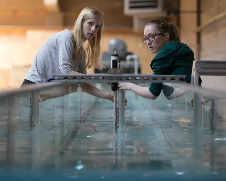 Engineering students using water tank