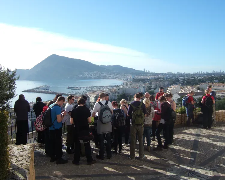 Students on a geography trip overlooking mountain and lake