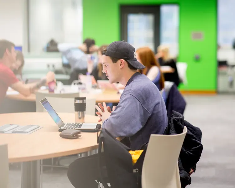 a student on a laptop at a table
