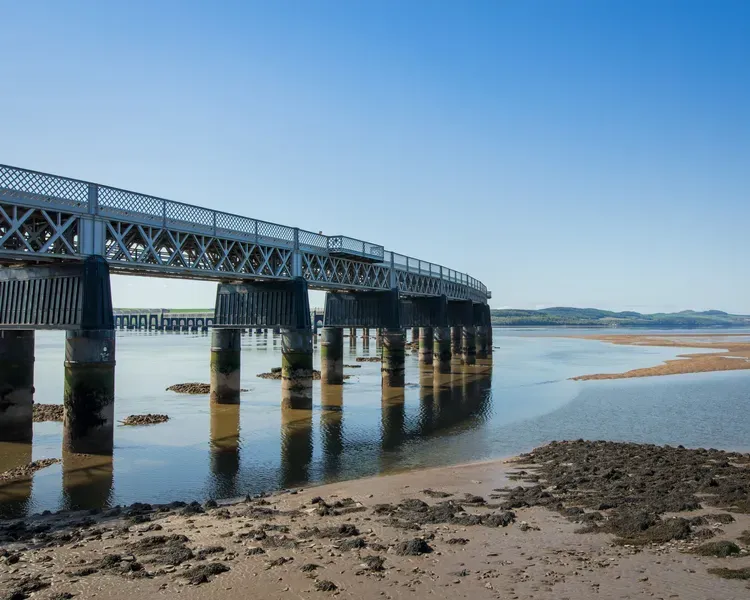 Tay Bridge on a sunny day with sandy shore nearby