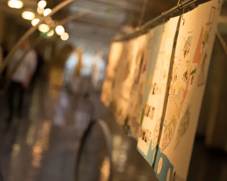 A warm-lit hallway with posters