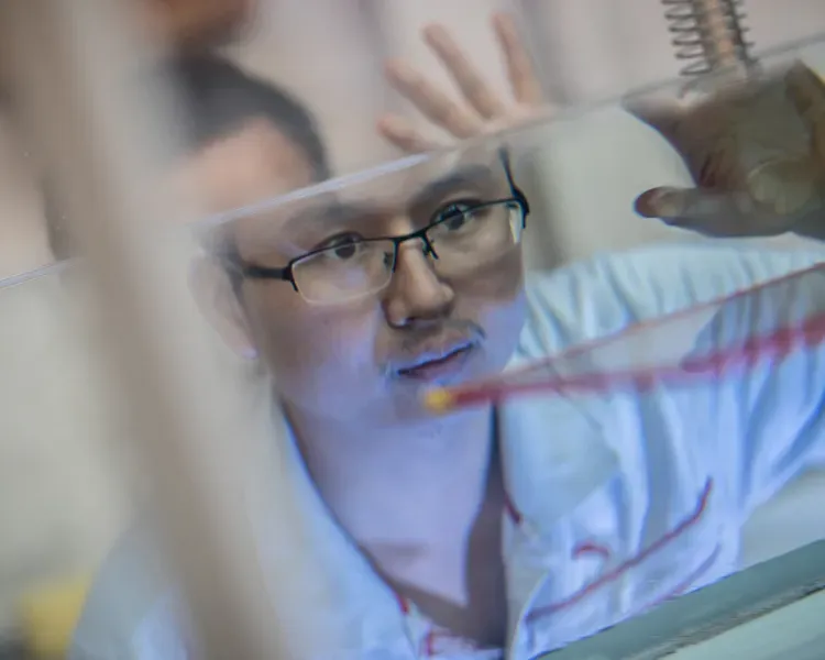A man staring into a water tank
