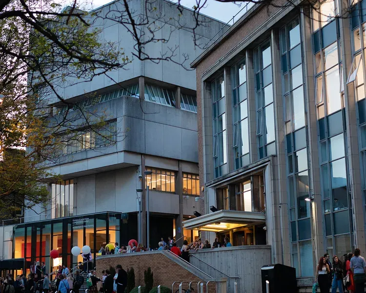 people standing outside the art school