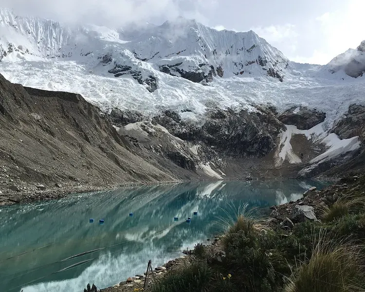Snow capped mountains around a frozen lake